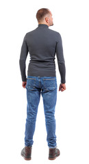 Back view of man in jeans.