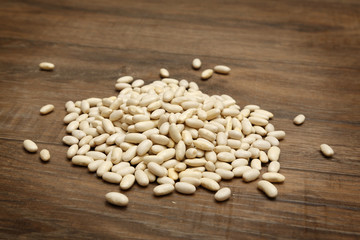 White beans on brown wooden table