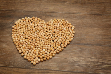 Heart of chickpeas on brown wooden table