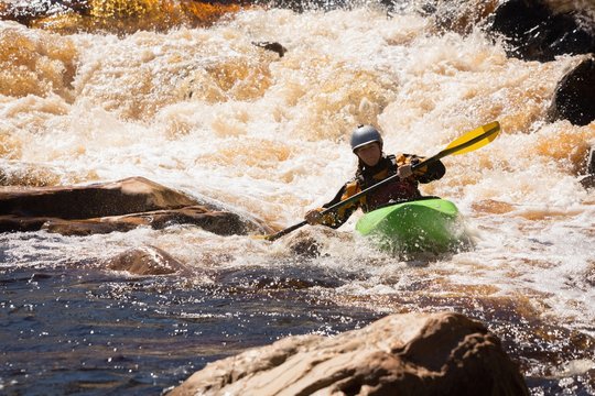 Woman kayaking in river