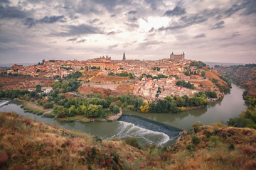 Fototapeta na wymiar Panorama of Old city of Toledo and river Tajo in the overcast day, Castilla La Mancha, Spain