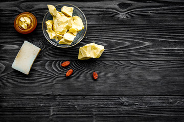 Cocoa butter as ingredient for natural cosmetics. Dark wooden background top view copy space