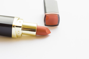 Make Up Beauty Concept. Matte coral lipstick in black tube on white background, close up