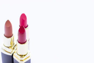 Make Up Beauty Fashion Concept. Matte red, pink and beige lipstick in black tubes on white background