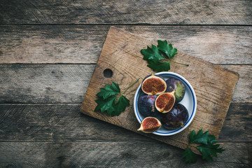 Ripe Figs on cutting board and wooden table