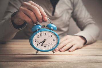 Man showing alarm clock.
