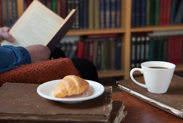 Sweet moments of relaxation with books and a cup of coffee. Vintage books, glasses, chair, library,...