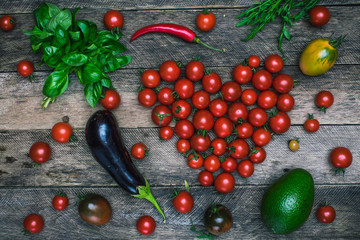 Tomato heart shape and vegetables as healthy lifestyle concept