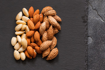 Three kind of almond: in shell, natural and peeled nut. Healthy food concept top view