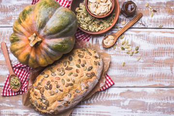 Newly baked bread with pumpkin and seeds wooden table