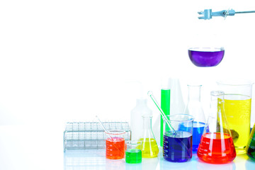 Laboratory glassware with colorful chemical reagent in research laboratory 
