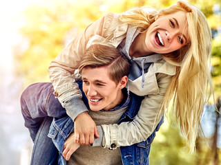 Fototapeta premium Adventure trips for couples. Spring people walking park and kissing. Summer friends walk outdoor. Weekends first date of two young person in good weather day. Toning of the spring photo.
