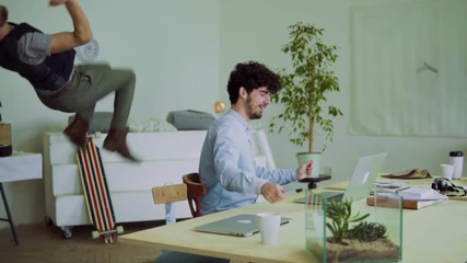 Young men celebrating success in an office.