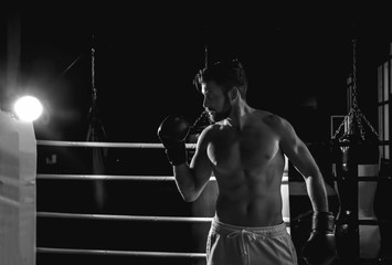 Young boxer training in ring before competition