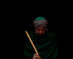 Muslim man with turban playing ney - Traditional sufi music