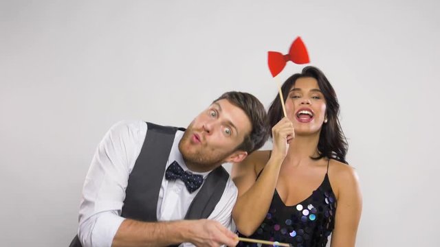 couple with party props having fun and posing