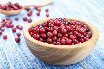Harvest fresh red cranberries in wooden plate
