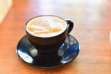 Isolated Cup of Latte Macchiato on Wooden Table