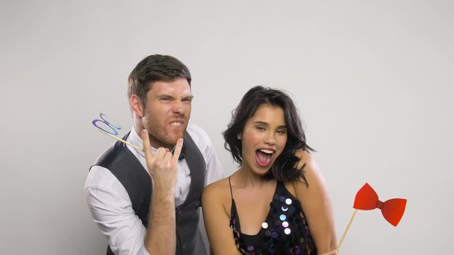couple with party props having fun and posing
