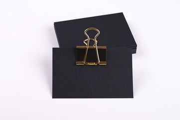 Black cards with golden clothespin on white background. Isolated. Mockup.