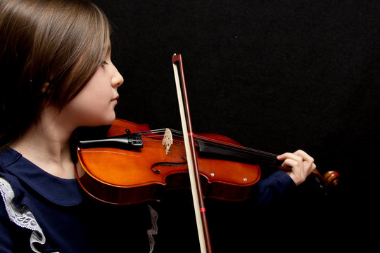 Little pretty girl playing violin