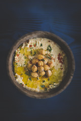 Homemade humus served on the wooden table,selective focus