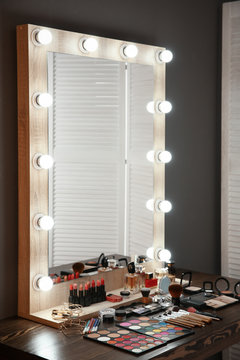 Workplace of professional makeup artist with large mirror and cosmetic