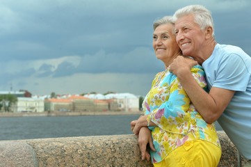 Fototapeta na wymiar senior couple on city street near river