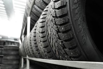 Rack with variety of car tires in automobile store