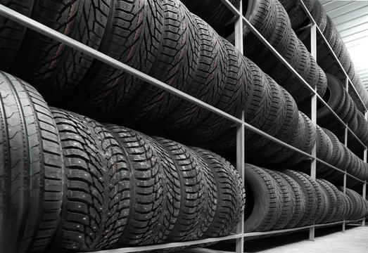 Rack with variety of car tires in automobile store