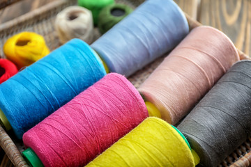 Wicker tray with set of color sewing threads, closeup