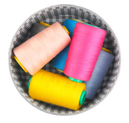 Box with color sewing threads on white background