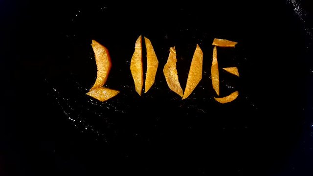 Fry carrots in the form of the word "love" in a frying pan