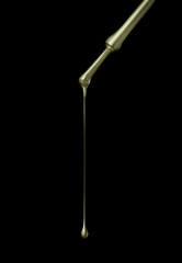 green nail polish brush on black background.jpg