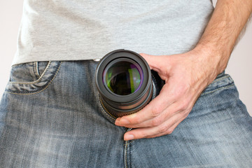 camera lens out of jeans like mens penis. Potency sexual problems and pornography concept. Man with...
