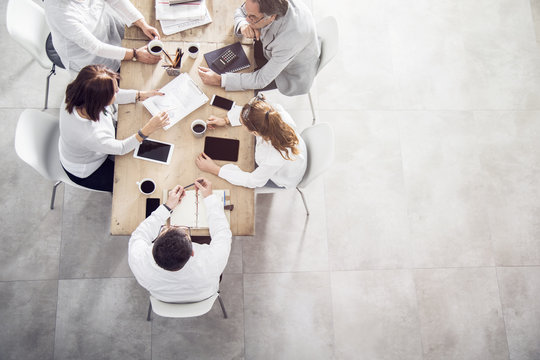 Top View In Office While People Having A Meeting