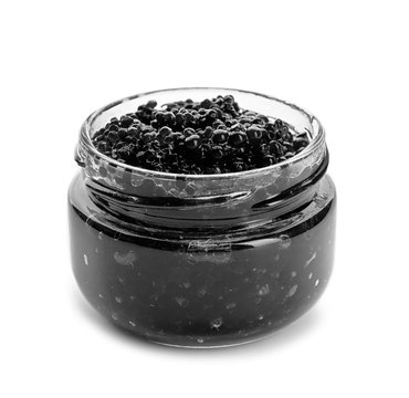 Black caviar in glass jar on white background