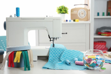 Sewing machine with thread and fabric on table