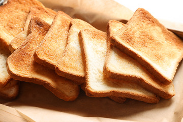 Toasted bread on parchment paper, closeup