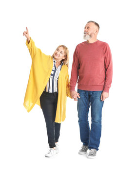 Mature Couple In Casual Clothes Walking On White Background