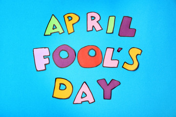 Phrase "April fool's day" on color background