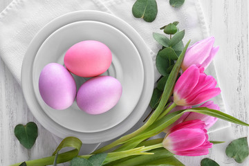 Obraz na płótnie Canvas Beautiful festive Easter table setting with tulips and eggs