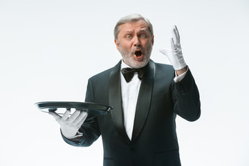 Senior waiter holding tray