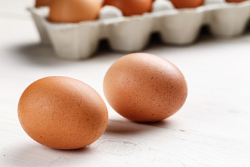 chicken eggs on a white wooden background