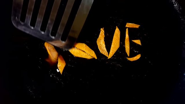 Form the word "love" in a frying pan from carrots