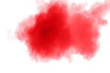 abstract red dust splattered on  white background. Red powder explosion on white background. Freeze motion of red particles splash.