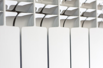 white radiator background. Close up elements modern battery - source of heat