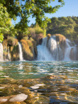 Waterfall in Krka National Park, famous Skradinski buk, one of the most beautiful waterfalls in Europe and the biggest in Croatia, blurred defocused background, vertical image