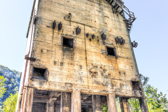 Abandoned retro vintage concrete loading receiving terminal building exterior in Thurmond, West Virginia ghost town with decaying structure walls, windows