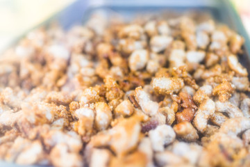 Macro closeup of fried roasted coated nuts cashews peanuts in NYC New York City Street food truck